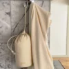 Microfiber Hair Towel and its pouch hanging on a bathroom hook