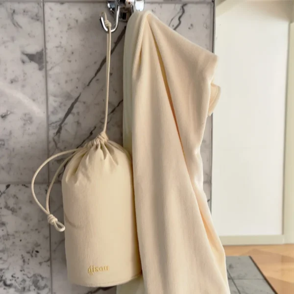 Microfiber Hair Towel and its pouch hanging on a bathroom hook